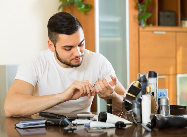 Man doing manicure at home