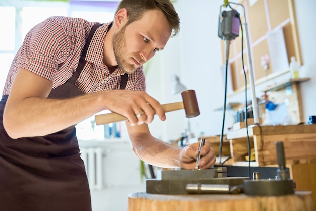 Man Doing Metalwork in Small Studio