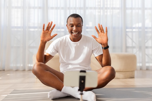 Man doing online yoga class from home