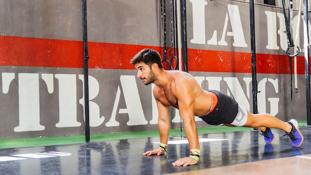 Man doing push ups in gym