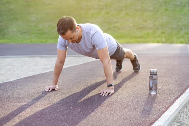 Man doing push ups outdoors