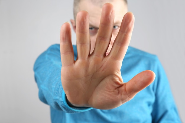 Man doing stop gesture with the right handxa