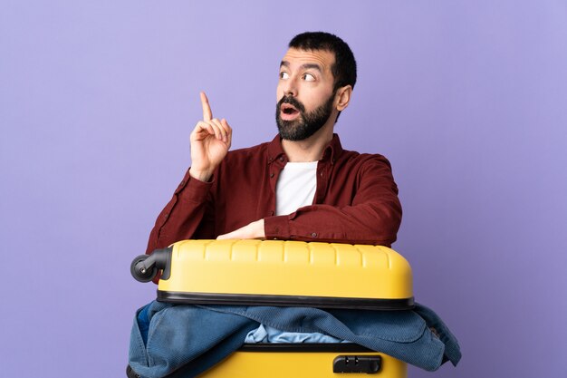 Man doing suitcase over isolated wall