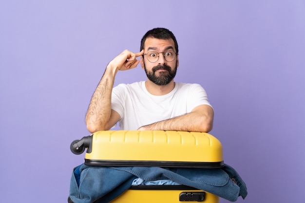 Man doing suitcase over isolated wall