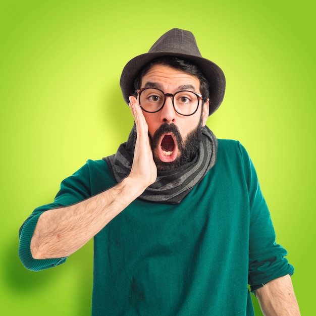 Man doing surprise gesture  on colorful background