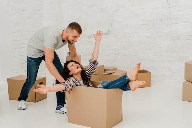 Man dragging woman in box