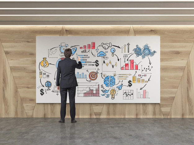 Man drawing startup sketch in wooden walls room