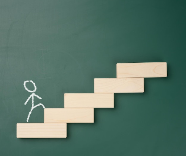 Photo a man drawn in white chalk walks up the wooden steps against the background of a green board career