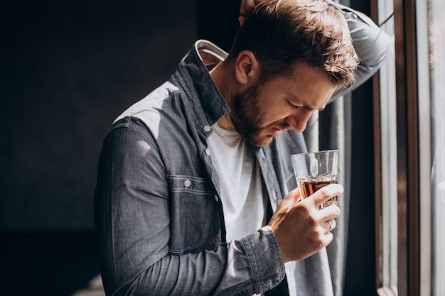 Man drinker depressed with bottle of whiskey