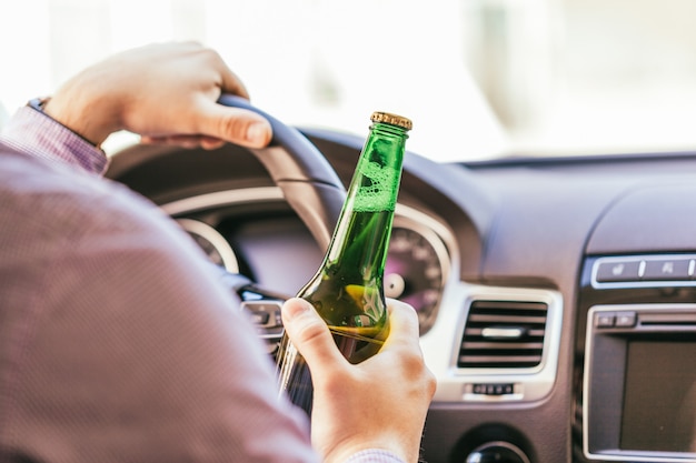 Man drinking alcohol while driving the car