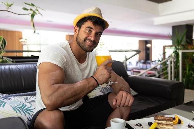 Man Drinking Cocktail in a Hotel Lobby Bar