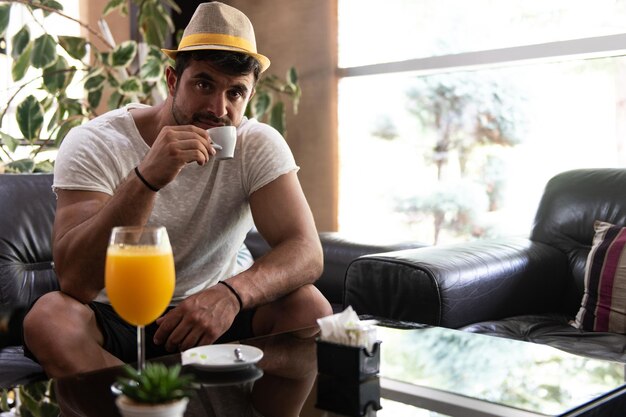 Man Drinking Coffee in a Hotel Lobby Bar