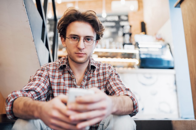 Man drinking a cup of coffee in the cafe.