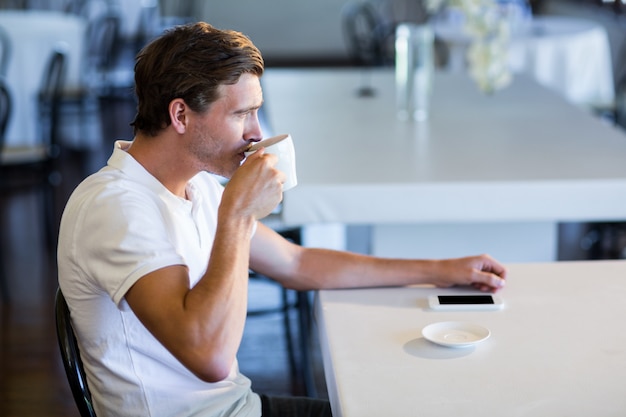 Man drinking cup of coffee