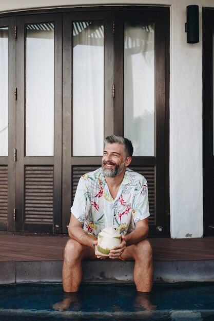 Man drinking a fresh coconut