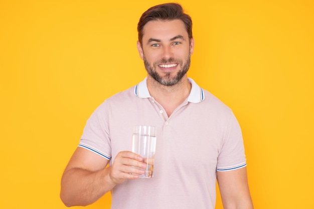 man drinking fresh water isolated on studio background man holds glass of water mineral water refres