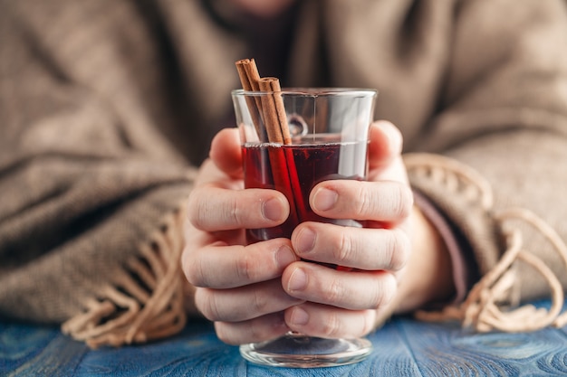 Man drinking hot red wine with spices