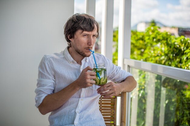 Man drinking a mojito on the terrace