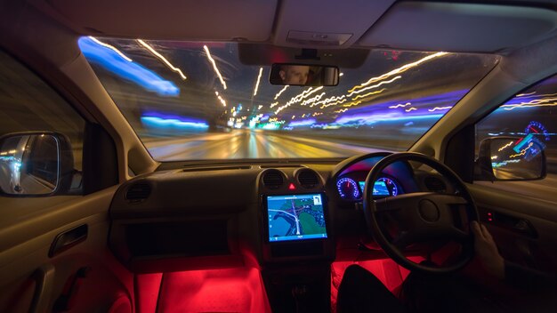 The man drive on the highway. Evening night time. Left side traffic