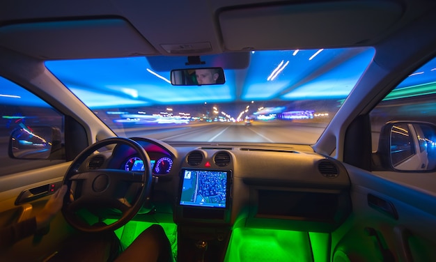 The man drive in the road with a navigation. Evening night time. Wide angle