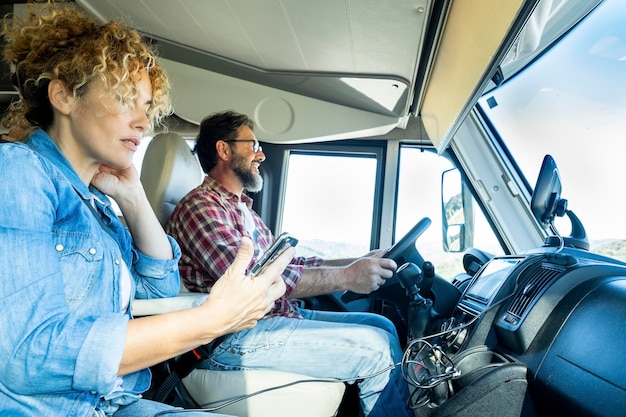 Man driving camper smiles while driving with his wife company Concept of travel vacation and life together