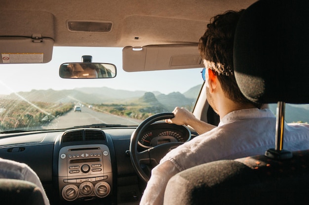 man driving car during day