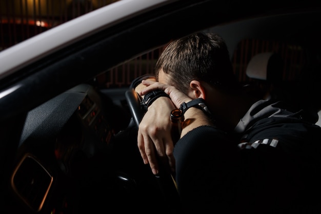 Man driving car and falling asleep at the wheel