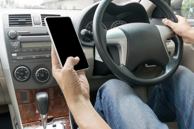 Man driving car and using mobile phone