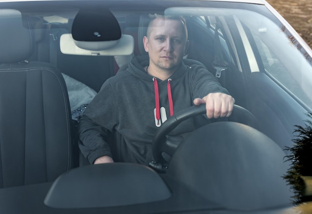 Man driving a car. View through the windshield