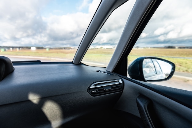 A man driving a car with a front view of the road