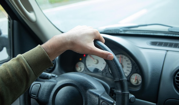 Man driving his car on way of outdoor