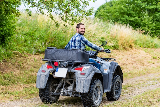 Man driving off-road with quad bike or ATV