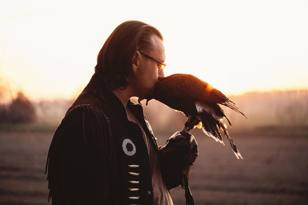 Man and eagle wild bird over sunset sky Eyesight