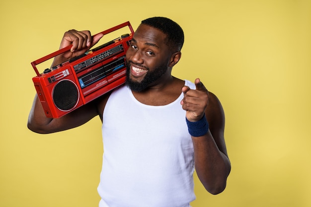 Man ears the music with an old stereo and dances