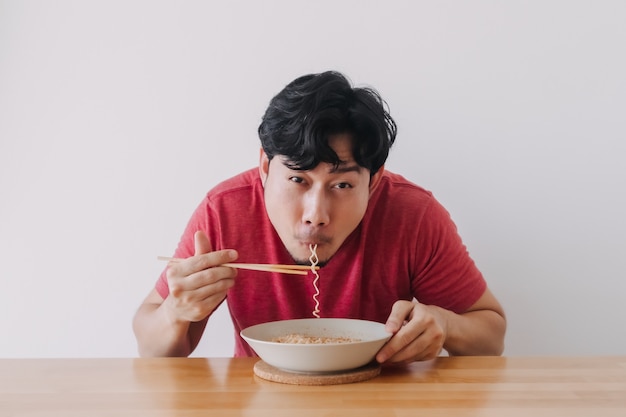 Man eating instant noodle very deliciously