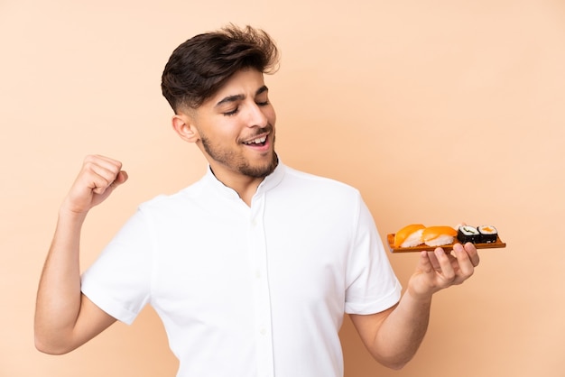 Man eating sushi in studio