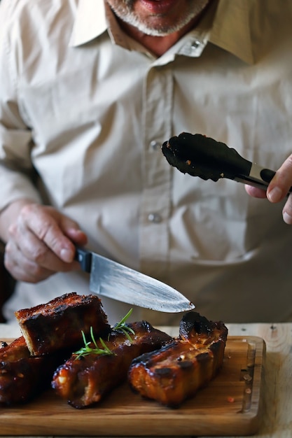 Man eating tasty pork ribs