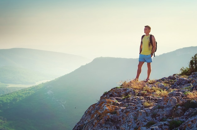 Man on edge of mountain. Traveling life.