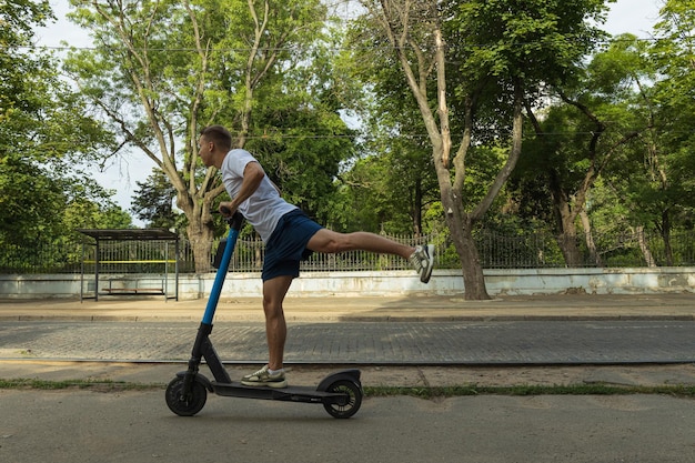 A man on an electric scooter in the park