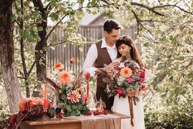 A man embraces a girl with a bouquet in her hands