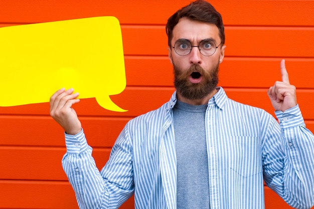 Man emotion face holding speech bubble looking at camera