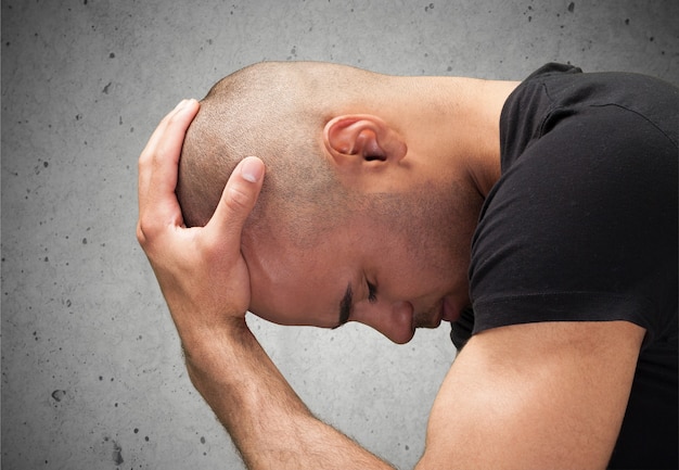 Man in Emotional Stress holding head with hands isolated on white