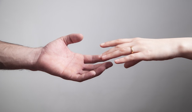 Man en vrouw handen op grijs