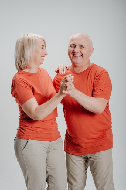 man en vrouw in oranje t-shirts op een witte achtergrond