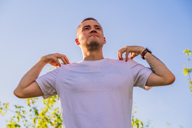 a man engages in outdoor training during a sunny day surrounded by green trees showcasing dedication to fitness and personal growth