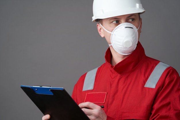 Man engineer, construction worker wearing face mask