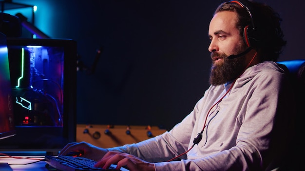 Man enjoying competitive online FPS videogame battling flying robots with his friends