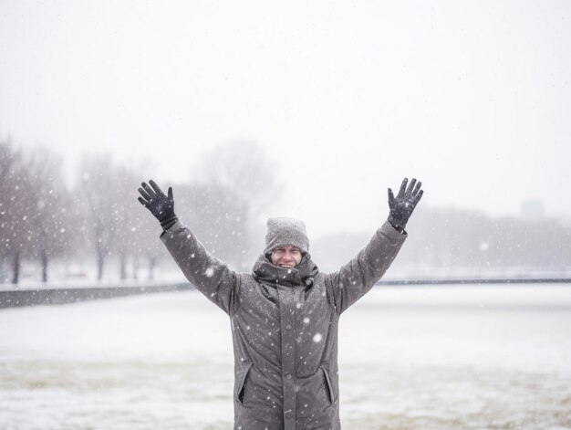 Man enjoys the winter snowy day in playful pose