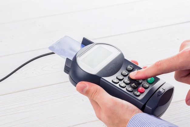 Man entering his pin on terminal