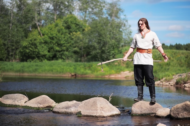 A man in ethnic clothes is a Scandinavian peasant